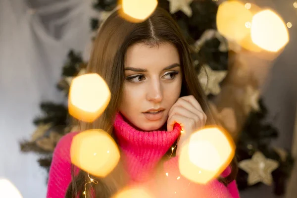 woman cozy christmas portrait with lights