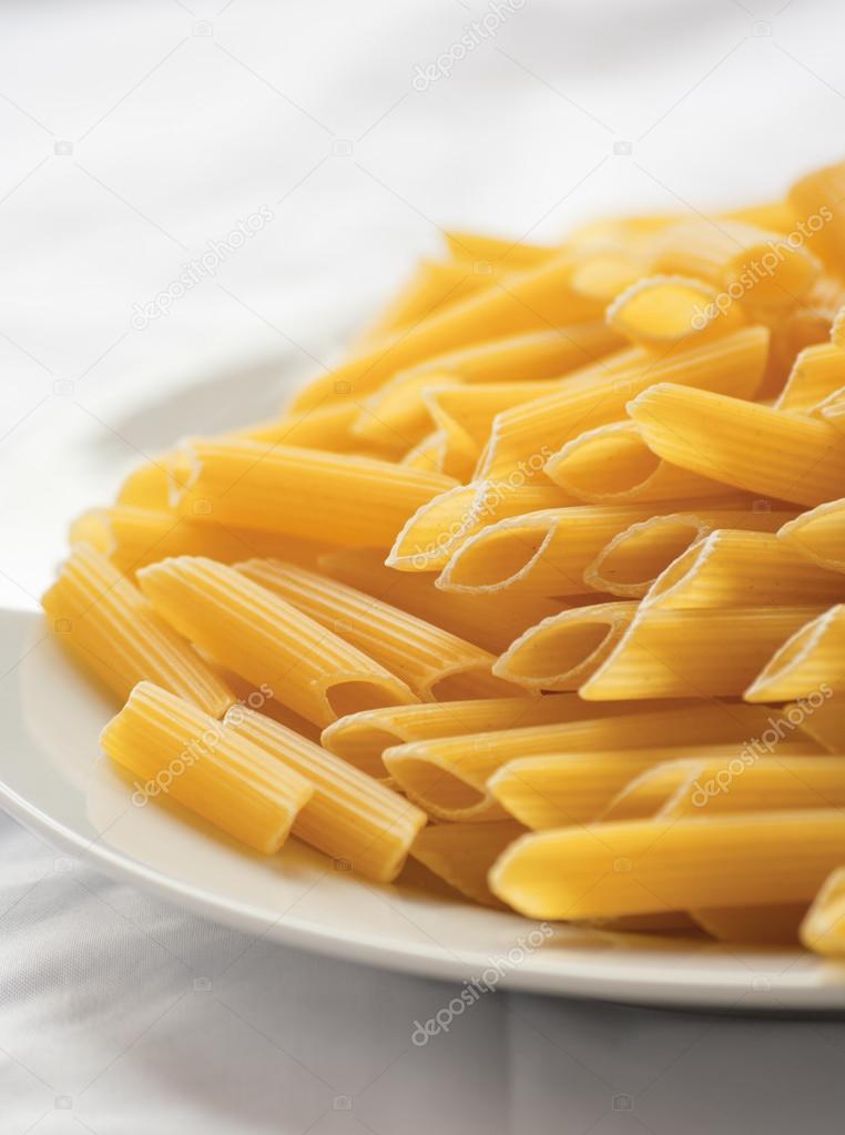 Dried italian pasta (macaroni) isolated on white background