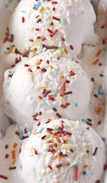 Scoops of vanilla ice cream in bowl with sprinkles — Stock Photo, Image