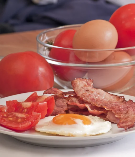 Fried egg with bacon and tomato Stock Picture