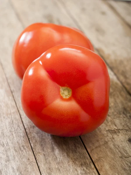 Tomato on wooden background — Stock Photo, Image