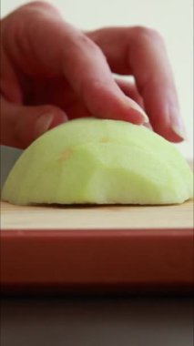 Tahtada taze yeşil demirci elması dilimliyorum. Yaklaş.