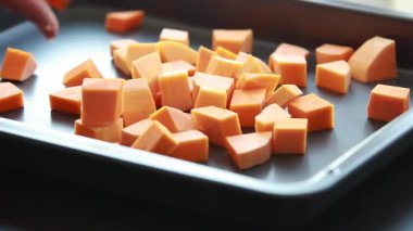 Pişirme tepsisine yerleştirilmiş taze kabak küpleri