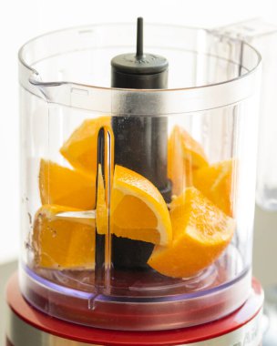 close-up of fresh orange pieces in a blender
