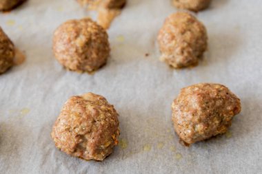 close-up of baked turkey meatballs in a baking tray