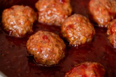 cooked turkey meatballs in pan with cranberry sauce