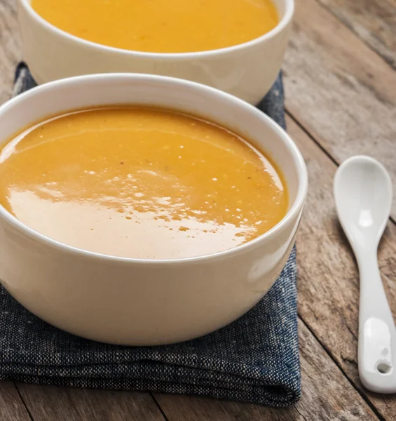 Two bowls of squash soup on wooden table — Stock Photo, Image