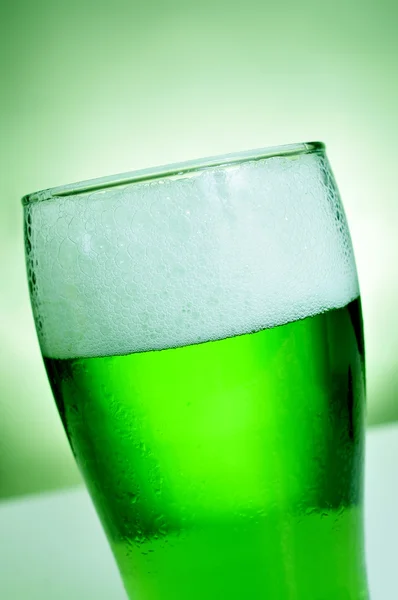 Glass with dyed green beer — Stock Photo, Image