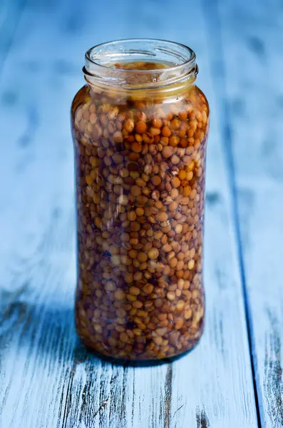 Cooked lentils in a glass jar — Stock Photo, Image
