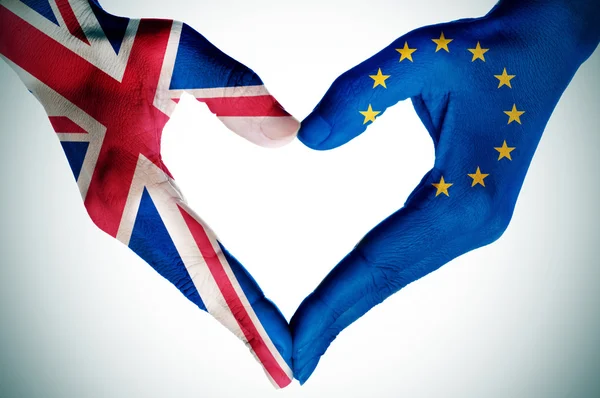 Hands patterned with the British and the European flag forming a — Stock Photo, Image