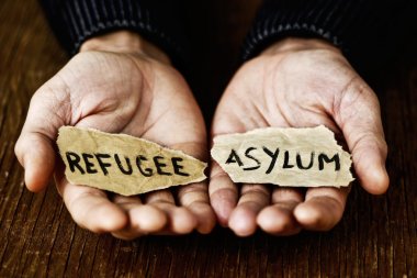 pieces of paper with words refugee and asylum clipart