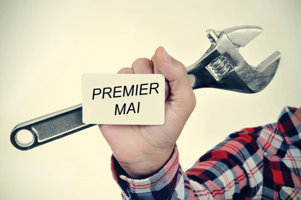 Man with adjustable wrench and signboard — Stock Photo, Image