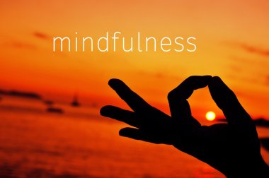 text mindfulness and hand in gyan mudra at sunset clipart