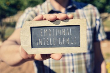 man with a chalkboard with the text emotional intelligence clipart