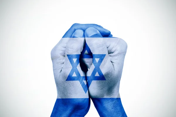 Hands patterned with the flag of Israel — Stock Photo, Image