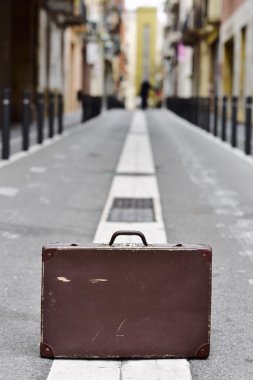 old suitcase in the middle of the street clipart