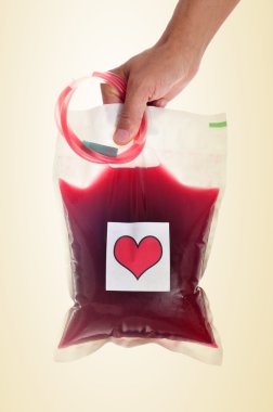 man holding a blood bag with a sticker of a red heart clipart