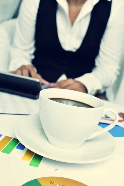 Businesswoman using an electronic calculator in her office — Stock Photo, Image