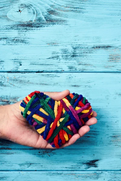 Man with a rainbow-patterned heart — Stock Photo, Image