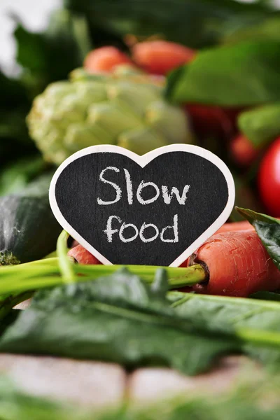 Raw vegetables and text slow food — Stock Photo, Image