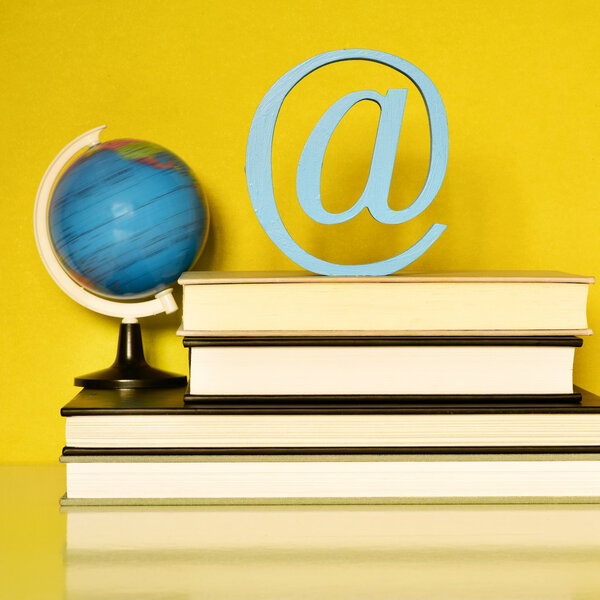 globe, books and at sign