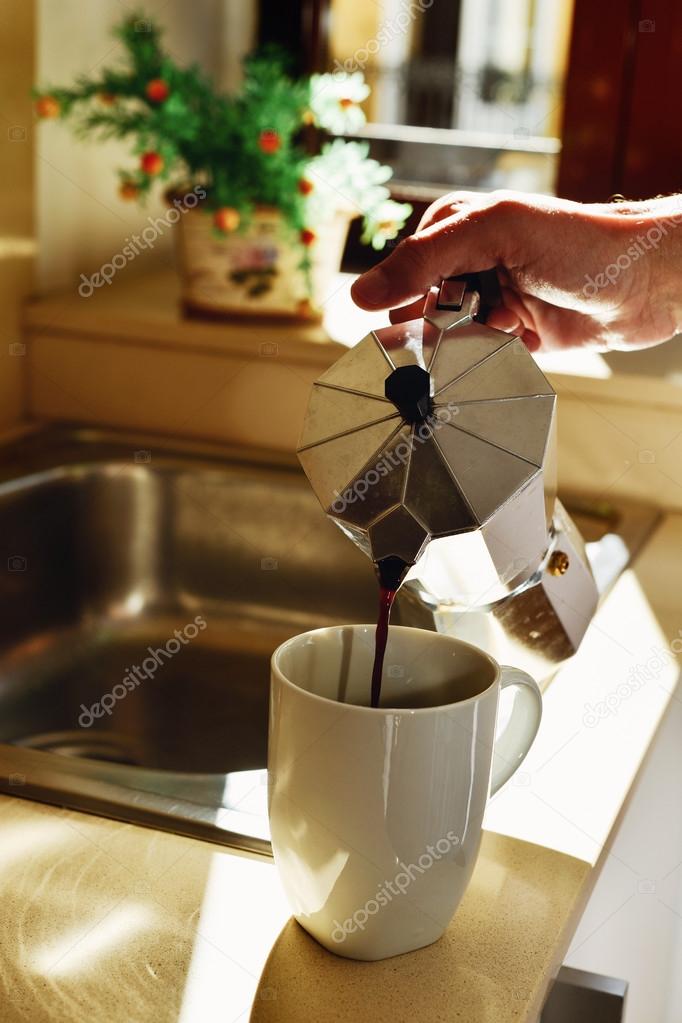 Man serving coffee from a moka pot Stock Photo by ©nito103 117806646