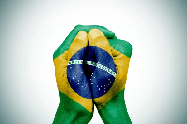 Hands patterned with the flag of Brazil — Stock Photo, Image