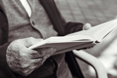 old man reading a book, in black and white clipart