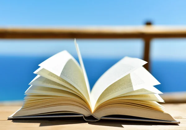 Open book in front of the ocean — Stock Photo, Image