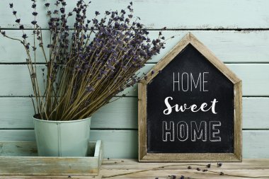 text home sweet home in a house-shaped signboard clipart