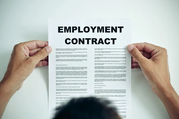 Man reading an employment contract — Stock Photo, Image