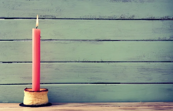 Lit candle on a cheesecake — Stock Photo, Image