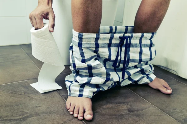 Young man in the toilet — Stock Photo, Image