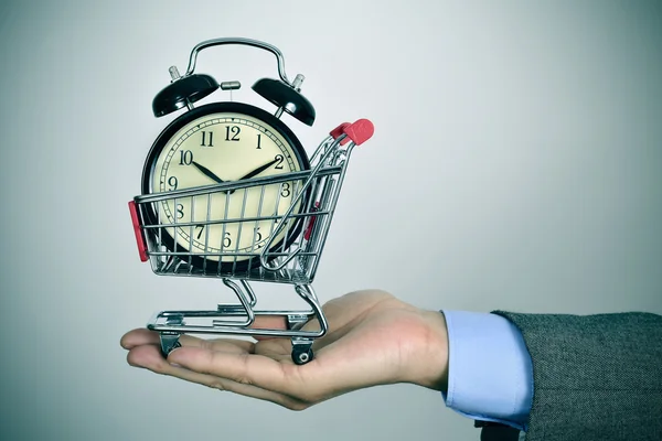 Businessman with an alarm clock in a shopping cart — Stock Photo, Image