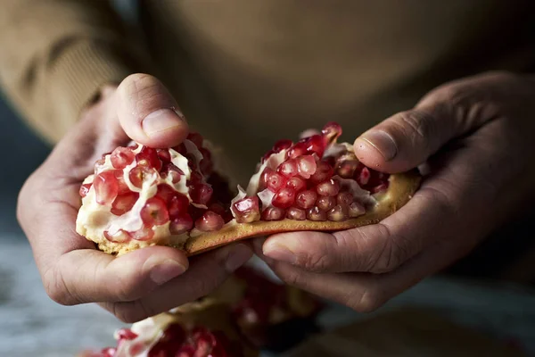 Closeup Young Caucasian Man Wearing Brown Pullover Opening Pomegranate Fruit — Stock Photo, Image