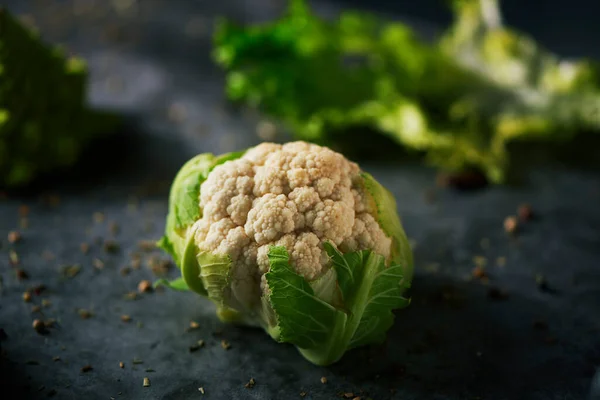 Raw Baby Cauliflower Head Placed Dark Stone Surface Sprinkled Different — Stock Photo, Image