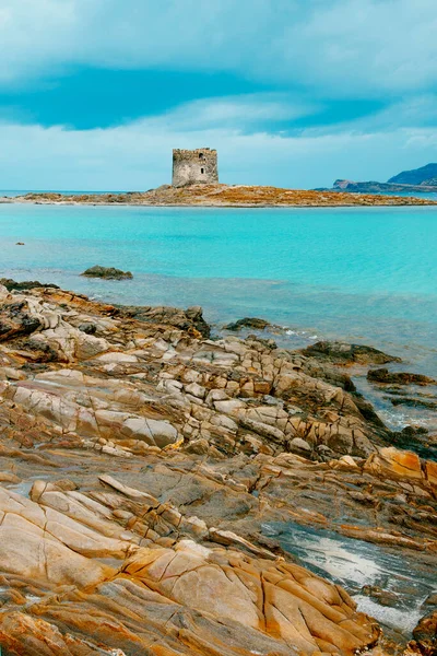 イタリアのサルデーニャ島の絵のように美しいスピッジャ デッラ ペローサのビーチでの岩の形成の眺め 背景にあるトーレ デッラ ペローサ塔とイゾラ ピアナ島 — ストック写真
