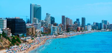 CALPE, İspanya - 2 AĞUSTOS 2021: İspanya 'da önemli bir yaz turizm merkezi olan Calpe ana plajının panoramik manzarası, karakteristik apartman kulelerini vurguluyor