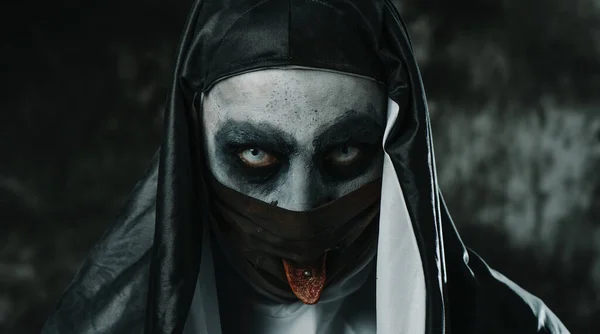 黒い顔のマスクの穴から彼女のピアス舌を突き出す 黒と白の習慣を身に着けている恐ろしい悪の修道女の閉鎖 — ストック写真