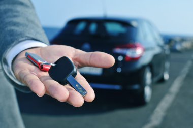 man offering a car key to the observer clipart