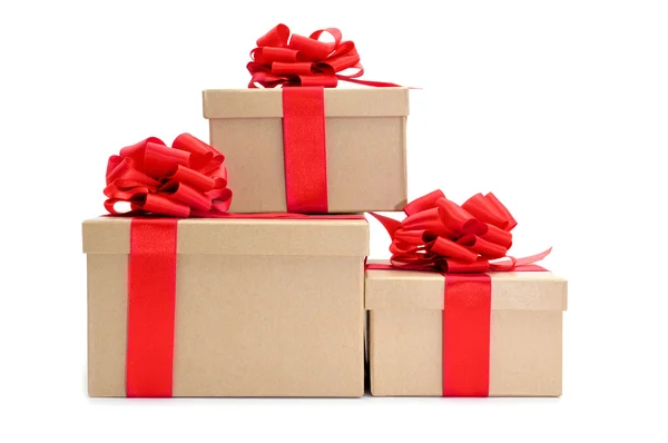 Cardboard gifts boxes with red ribbon bows — Stock Photo, Image