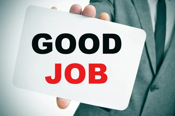 Businessman holding a signboard with the text good job — Stock Photo, Image