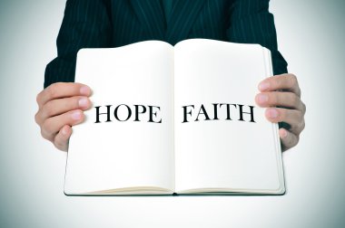 man showing a book with the words hope and faith clipart