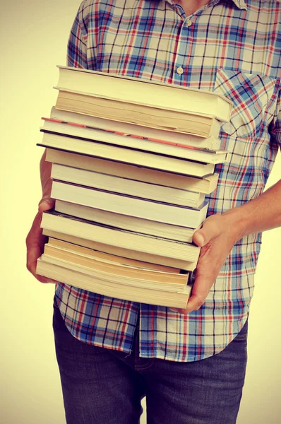 Young man with books, with a filter effect — Stock Photo, Image