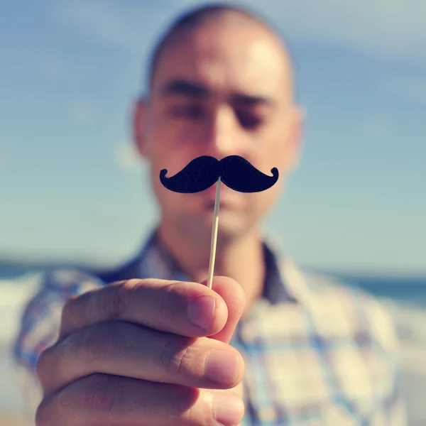 Young man with a fake moustache — Stock Photo, Image