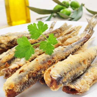 spanish boquerones fritos, battered and fried anchovies typical  clipart