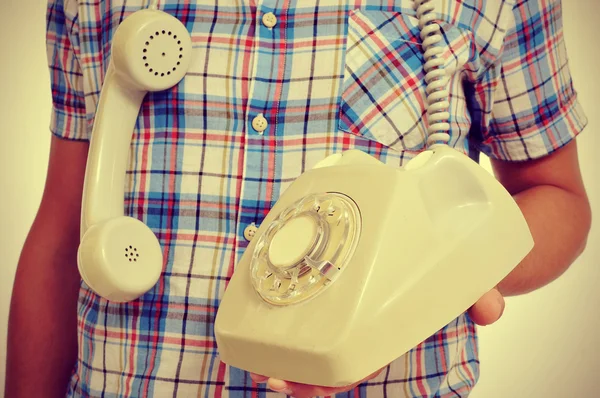 Jovem com telefone de discagem rotativa, com efeito retrô — Fotografia de Stock