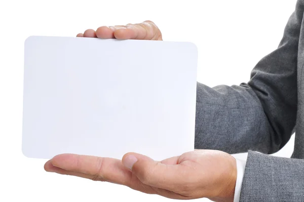 Man in suit holding a blank signboard — Stock Photo, Image