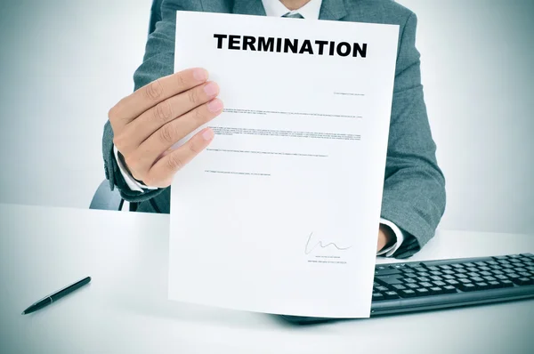 Man in suit showing a figured signed termination document — Stock Photo, Image