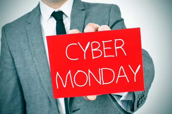 Man in suit with a signboard with the text cyber monday — Stock Photo, Image